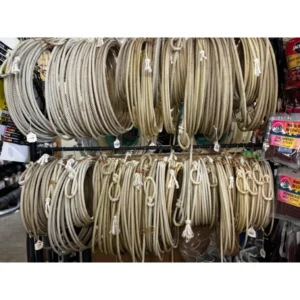 Display of multiple coiled beige cables hanging on hooks in a store.
