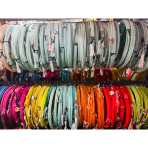 Colorful rolls of fabric organized in two rows by color.