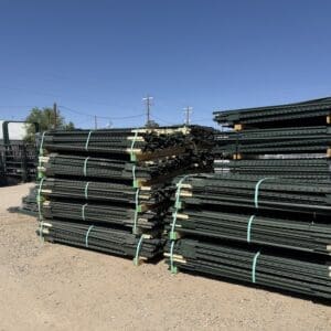 Stacks of metal fencing panels tied together outdoors.