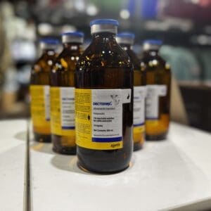 Brown glass bottles with white and yellow labels lined up on a table.