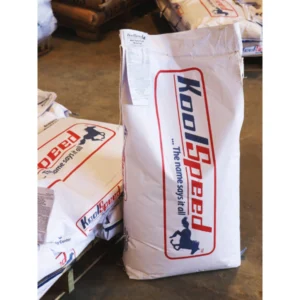 A large sack of Kool-Groed animal feed leaning against others.