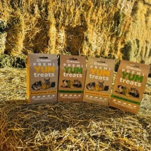 Boxes of small pet treats on hay